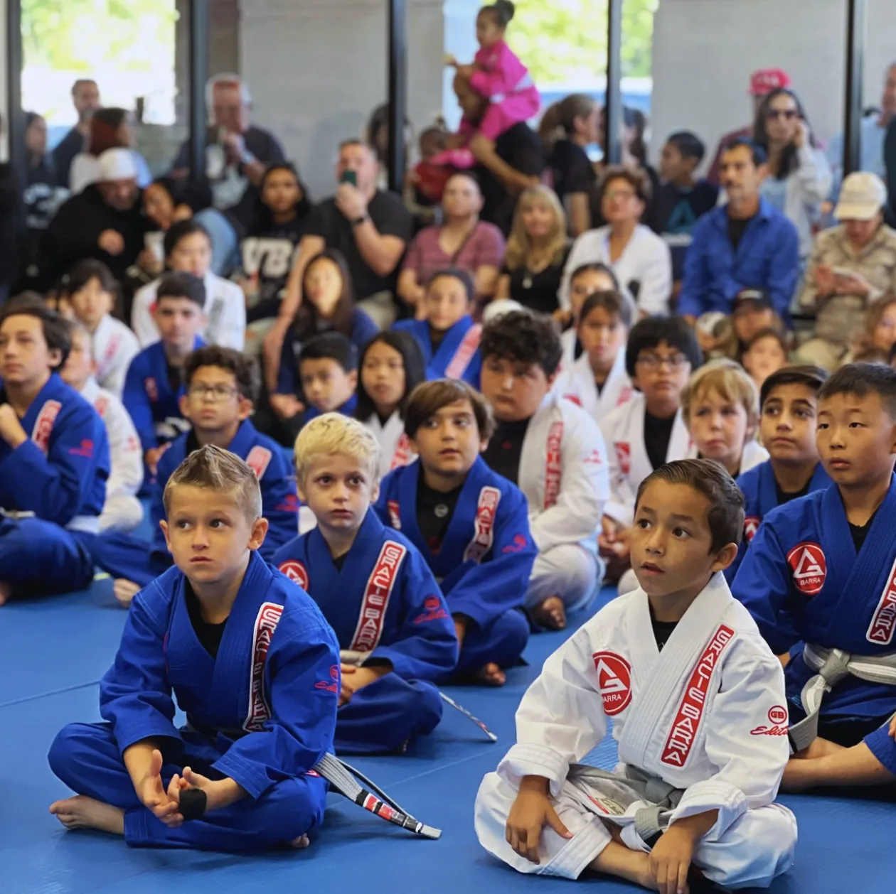 Gracie Barra kids class students sitting together on the mats